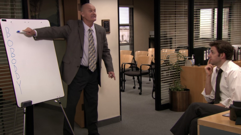 Creed pointing to BOBODDY whiteboard