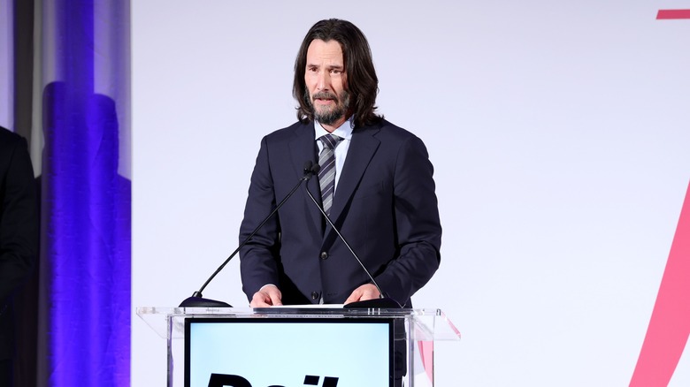 Keanu Reeves speaking at podium