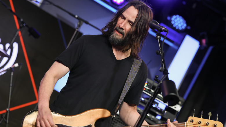 Keanu Reeves playing bass guitar