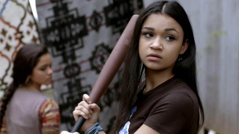 Madison Bailey with baseball bat