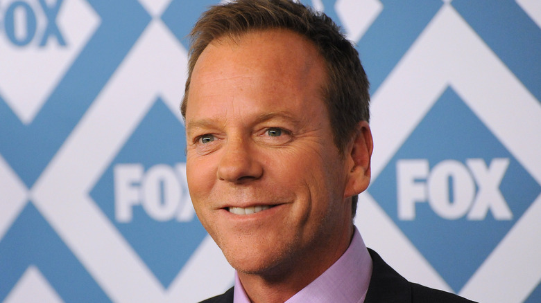 Kiefer Sutherland smiling for photographers