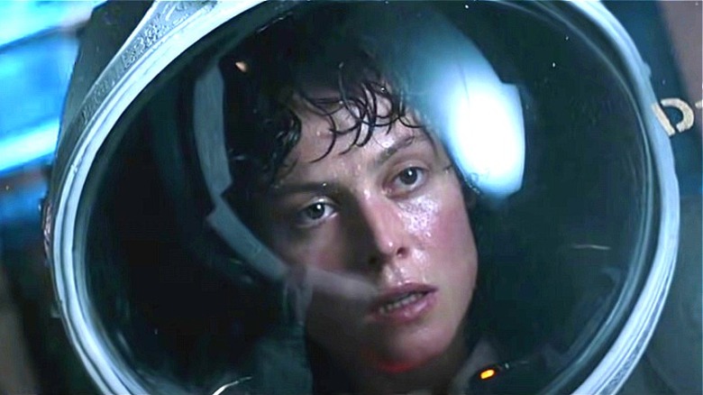 Ellen Ripley wearing a space suit and helmet