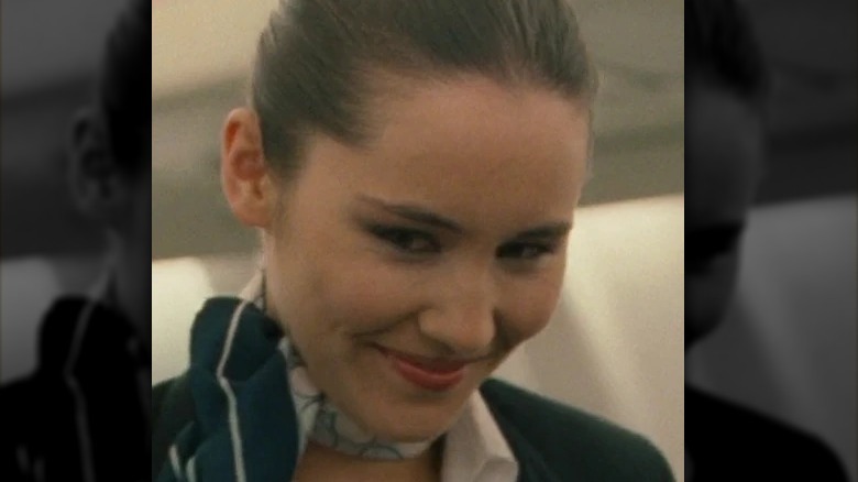 Christina Chong as stewardess smiling