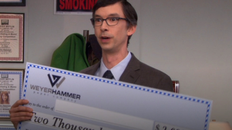 Robert holds a check from WeyerHammer paper