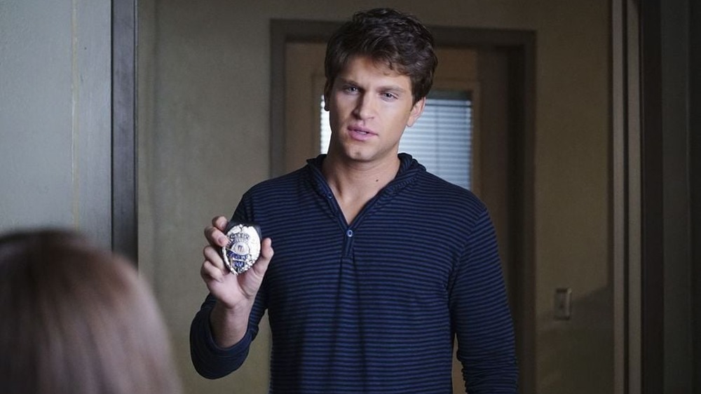 Toby Cavanaugh showing badge