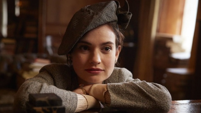 Lily James in hat leaning on bar in The Pursuit of Love