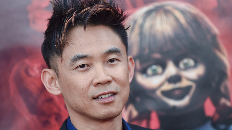 James Wan standing beside Annabelle art