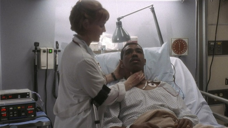 A doctor checking Al's throat