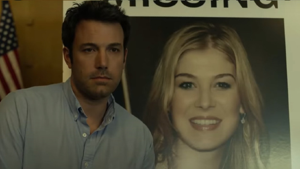 Ben Affleck stands in front of a missing poster in Gone Girl