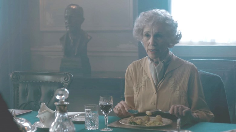 Clementine sits at a table eating potatoes