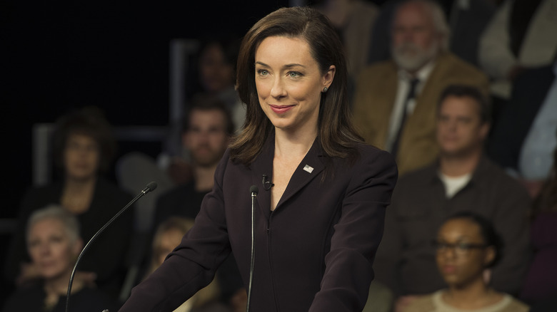 Molly pArker Jackie Sharp smiling debate podium