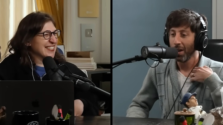 Mayim Bialik smiling as Simon Helberg talks