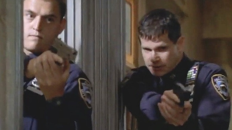 Dylan Walsh holding gun