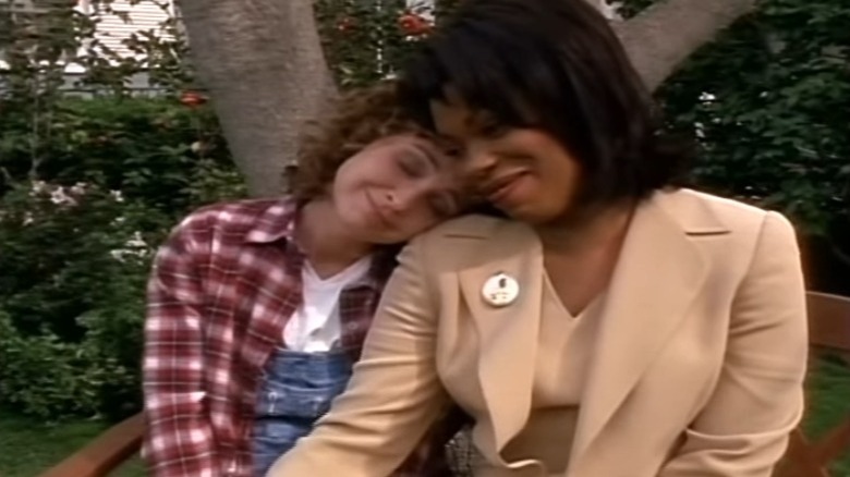 Mary Elizabeth Sims and Rene Jackson embrace on a bench