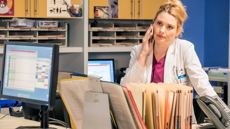 Sophie on her cell phone at the nurses' station