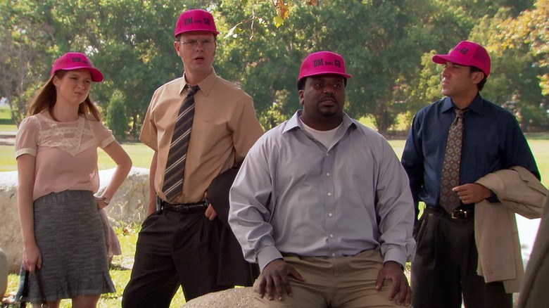 Erin, Dwight, Darryl, and Oscar wearing pink hats outside (The Office)