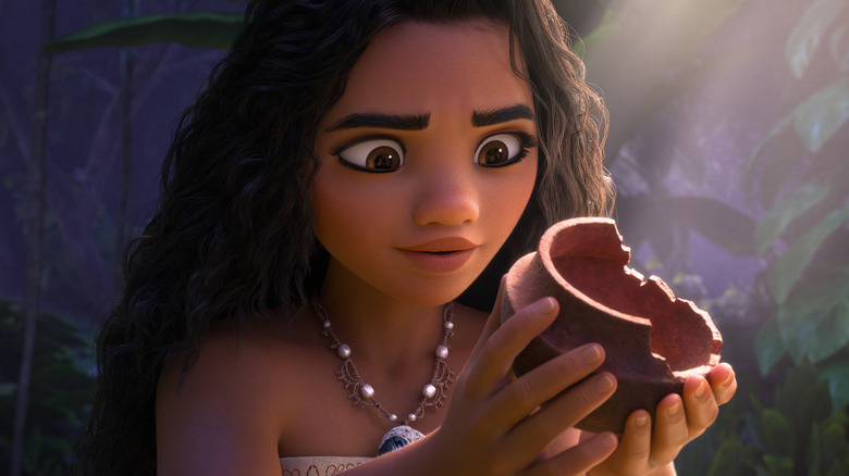 Moana examining a broken piece of pottery