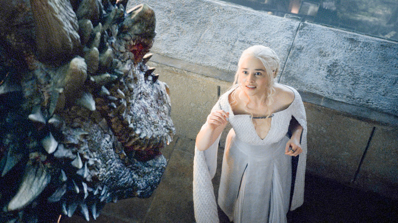 Daenerys smiling with dragon