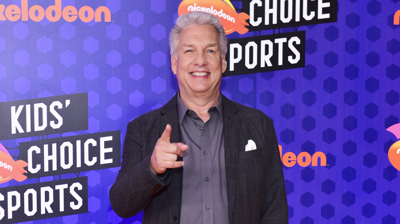 Marc Summers smiling and pointing