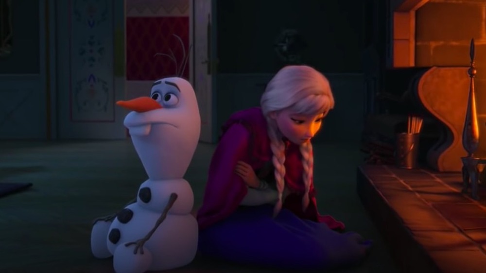 Olaf and Anna in front of the fire in Frozen