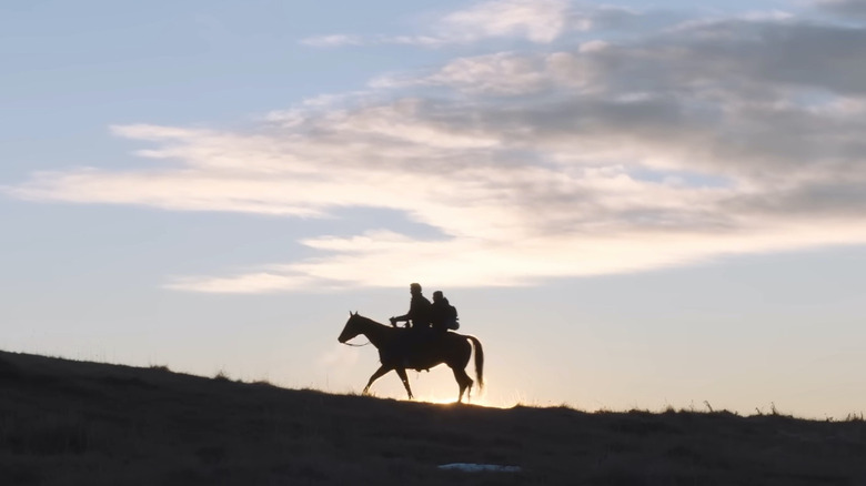 Joel and Ellie riding a horse together