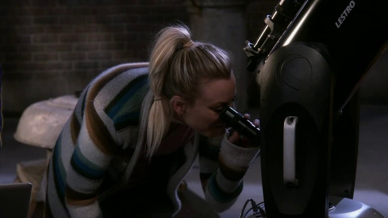 Penny Teller looking through a telescope