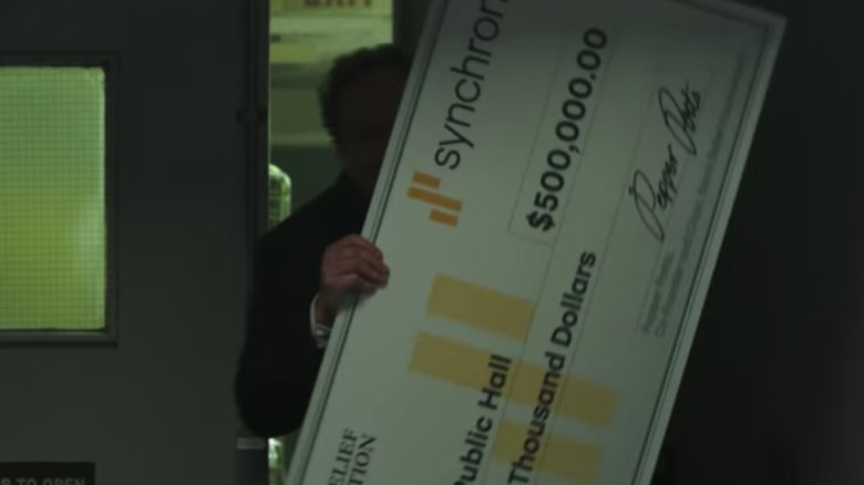 Happy Hogan comes, bearing a novelty check