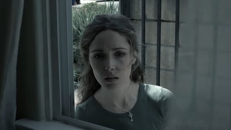 Rose Byrne staring through window in Insidious 