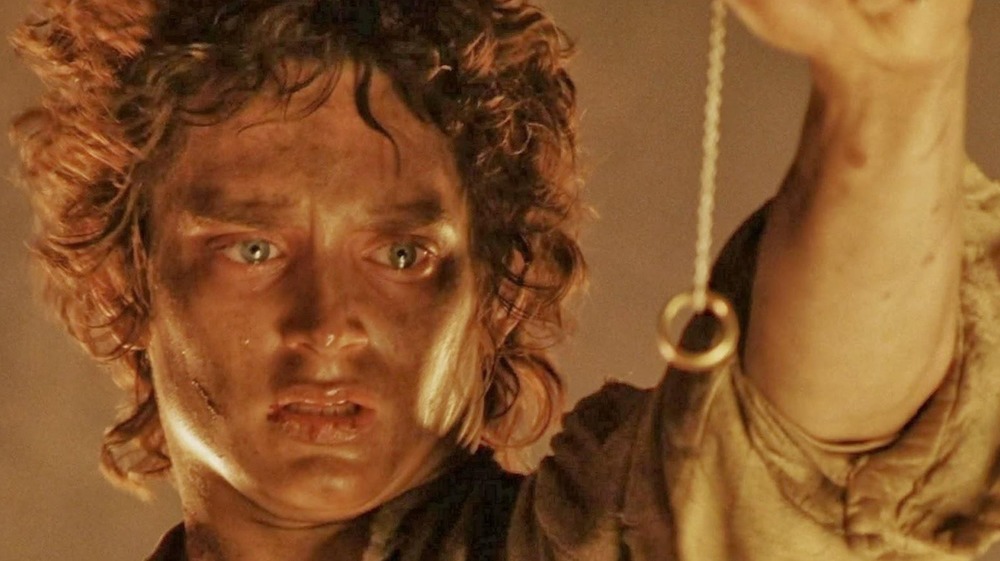 Frodo holding the One Ring