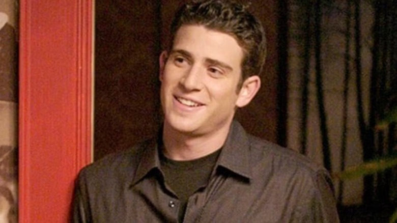 Jake leaning against a door in "One Tree Hill."