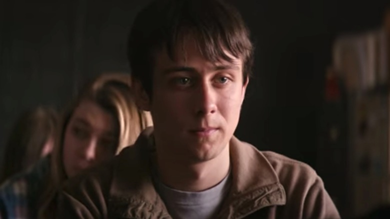 Campbell's character sitting in class looking contemplative in Super Dark Times