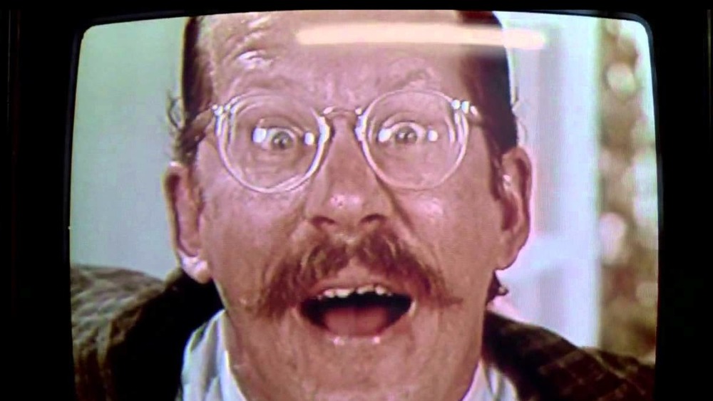 Crazy man on TV with glasses, mouth open