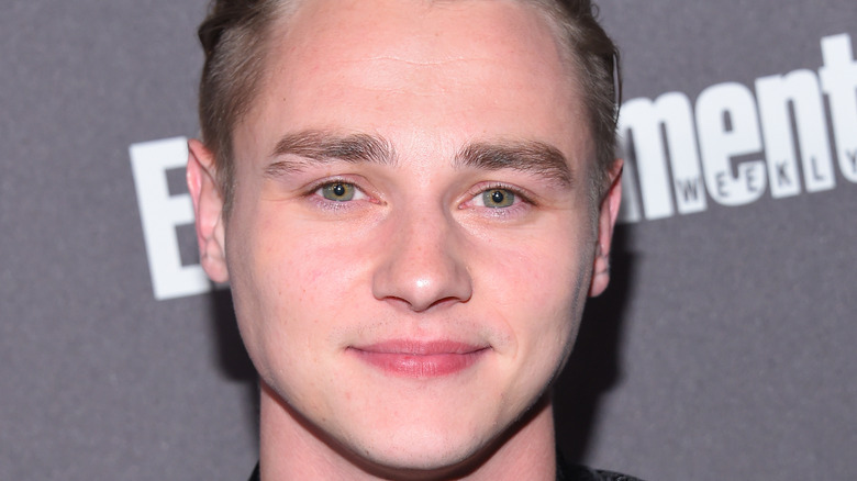 Ben Hardy smiling at event