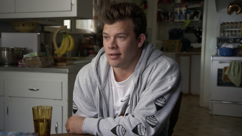 American Vandal Jimmy Tatro wears gray hoodie