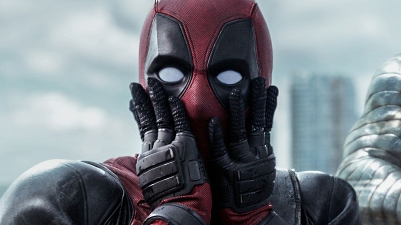 Deadpool holding his face