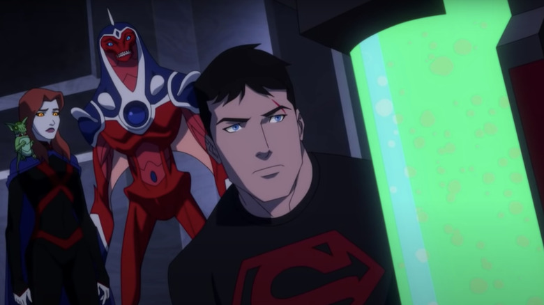 Superboy looks at a vile of green liquid