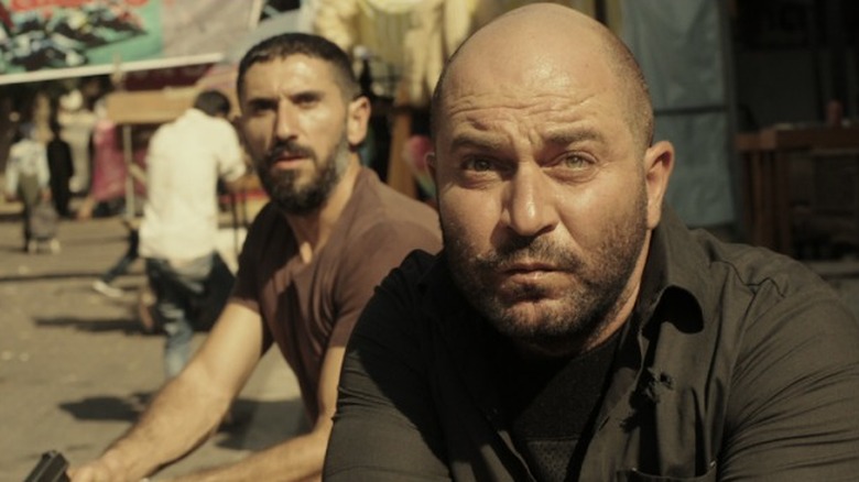 Lior Raz running with gun in Fauda