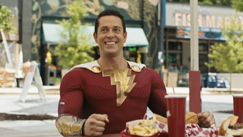 Shazam! smiling while eating junk food