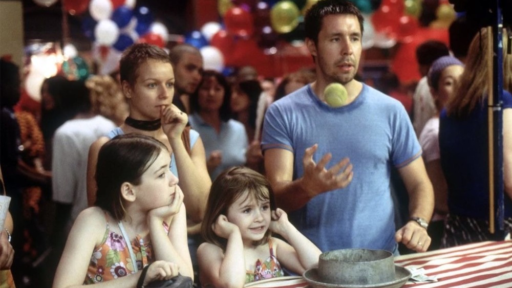 Johnny Sarah and their daughters playing game at a fair