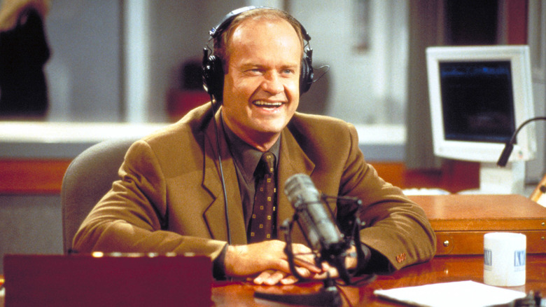 Frasier smiling at the radio station