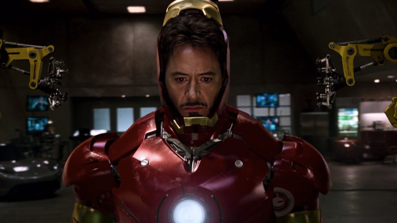 Tony Stark putting on Iron Man suit