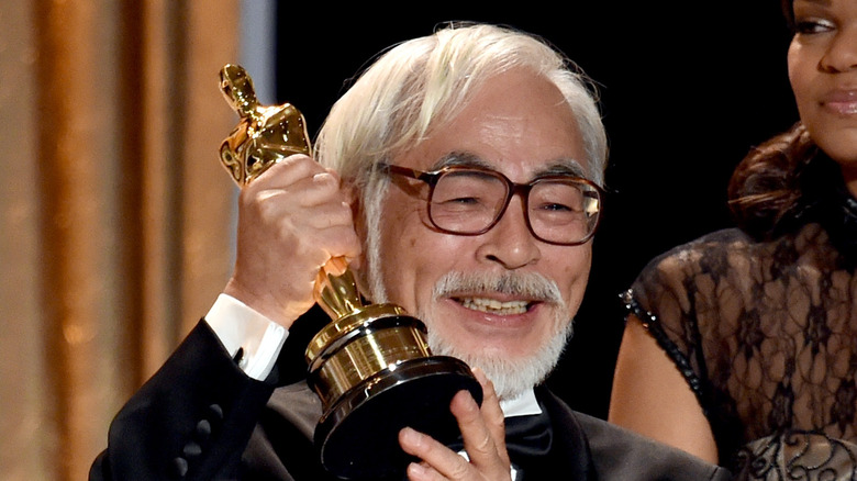 Hayao Miyzaki smiling with his Oscar award