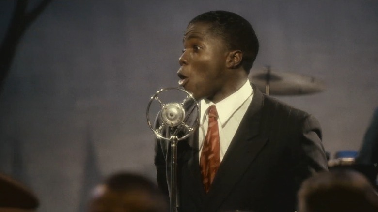 Louis Armstrong performs on stage