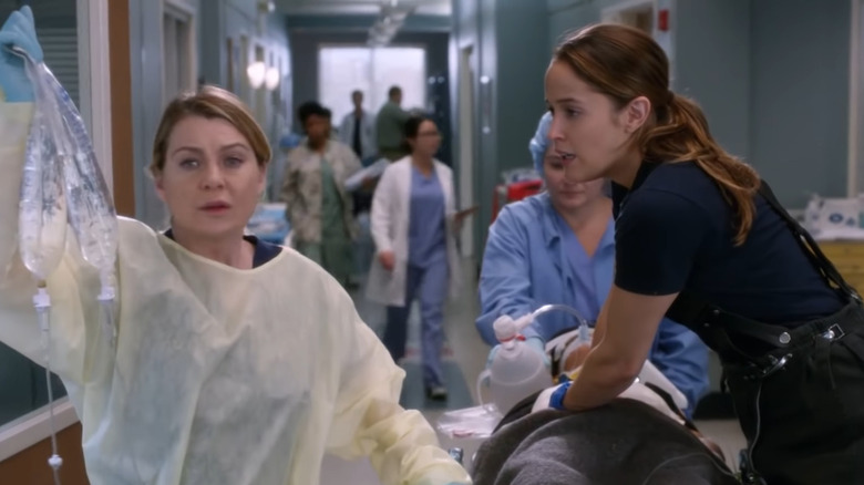Andy Herrera and Dr. Meredith Grey helping a patient.