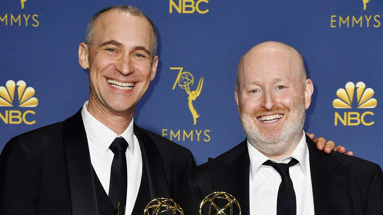 Joe Weisberg and Joel Fields smile and hold Emmys