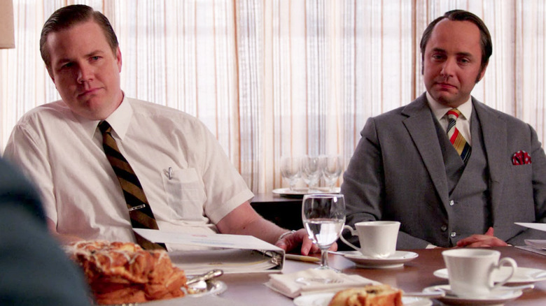 George Payton and Pete Campbell sitting at a table together in Mad Men