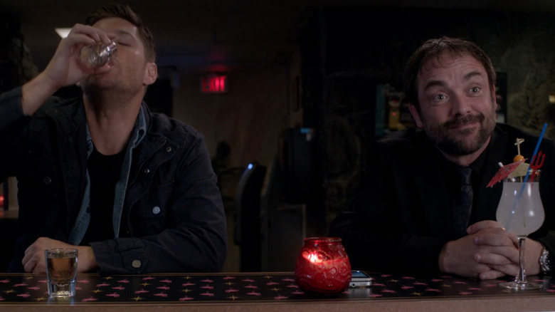 Jensen Ackles downs a drink alongside Mark Sheppard on Supernatural