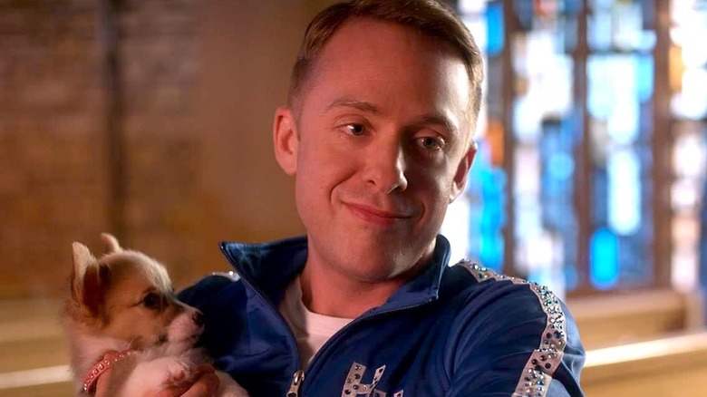 Christopher Doyle smiling and holding dog in church