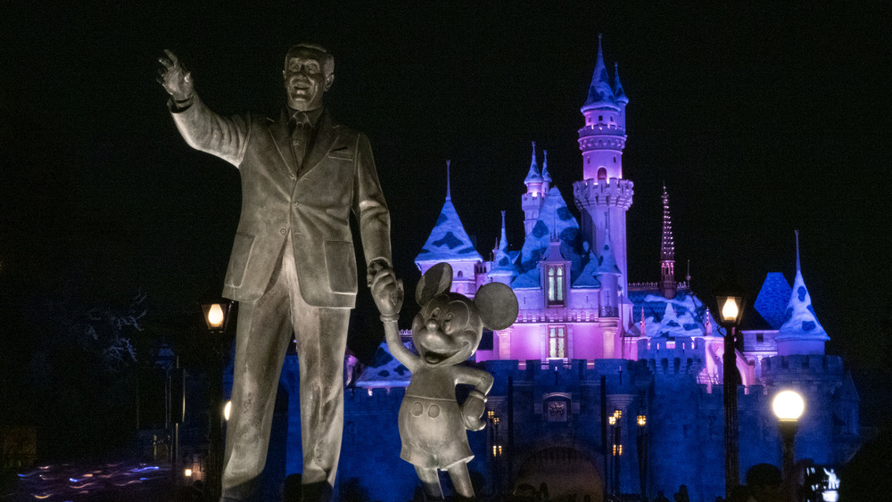 The "Partners" statue at Disneyland lit up at night