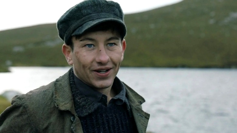 Dominic smiles by a lake in "The Banshees of Inisherin" (2022)